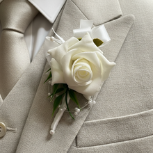 a childs bespoke ivory rose buttonhole  with ribbon bow and pearl loops