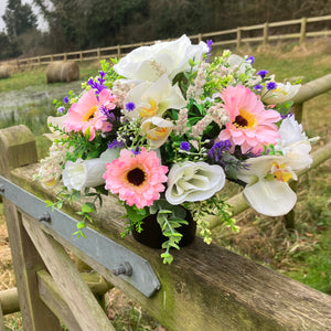 graveside artificial flower arrangement in shades of cream and pink