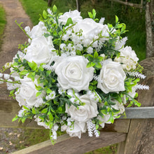 a wedding bouquet collection of white or ivory roses & lily of the valley