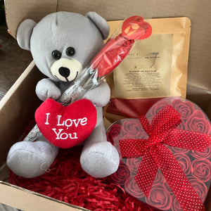A grey teddy with heart, red soap roses bath dust and sexy red lace g string for your valentine