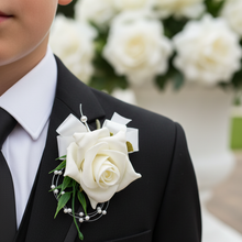 a childs bespoke ivory rose buttonhole  with ribbon bow and pearl loops