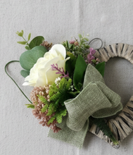 A heart wreath with silk of roses and foliage