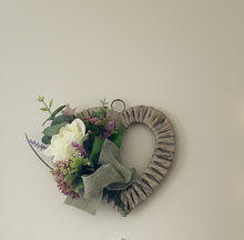 A heart wreath with silk of roses and foliage