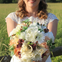 Brides bouquet of hydrangea, calla, rose flowers and foliage
