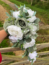 A teardrop wedding bouquet collection featuring sage and white roses