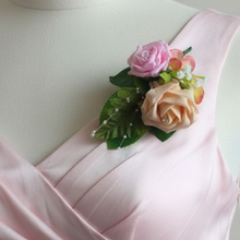 artificial corsage of pink and peach foam roses
