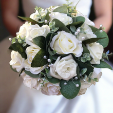 A teardrop wedding bouquet collection of artificial ivory roses