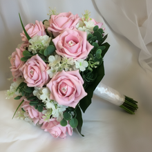 A brides wedding posy bouquet of pale pink foam roses and white lilac flowers