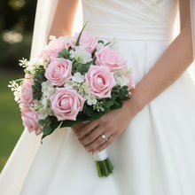 A brides wedding posy bouquet of pale pink foam roses and white lilac flowers