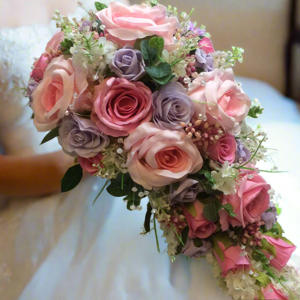 A wedding bouquet collection of artificial faux silk pink & lilac roses & crystals