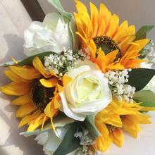 A teardrop bouquet collection of artificial ivory roses and sunflowers