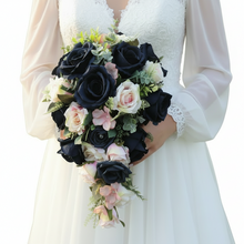 A teardrop bouquet of artificial navy and blush roses