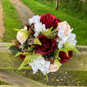 A bridesmaids or small brides bouquet featuring burgundy, mocha & white flowers