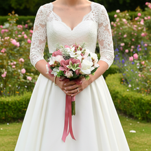 LAST ONE - A bridal bouquet featuring artificial flowers in shades of ivory and dusky pink