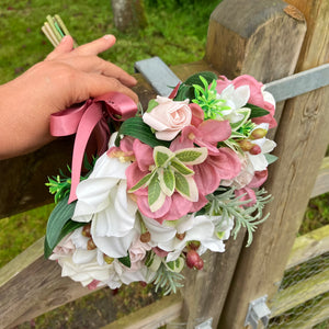 LAST ONE - A bridal bouquet featuring artificial flowers in shades of ivory and dusky pink