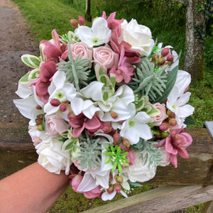 LAST ONE - A bridal bouquet featuring artificial flowers in shades of ivory and dusky pink