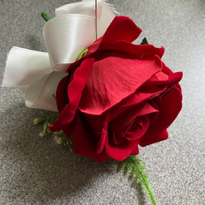 a brides bouquet of artificial silk red roses, waxflower and foliage