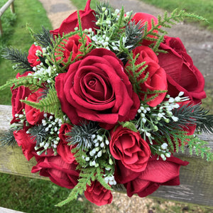 a brides bouquet of artificial silk red roses, waxflower and foliage