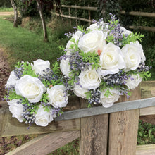 A bouquet collection of artificial silk ivory roses, foliage & blue berries