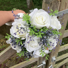 A bouquet collection of artificial silk ivory roses, foliage & blue berries