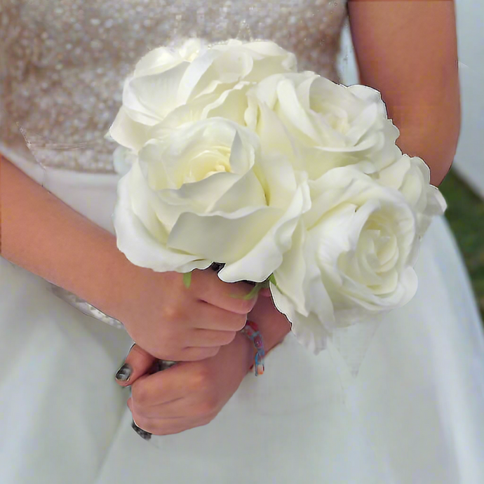 A bridesmaid's wedding bouquet of artificial silk ivory roses