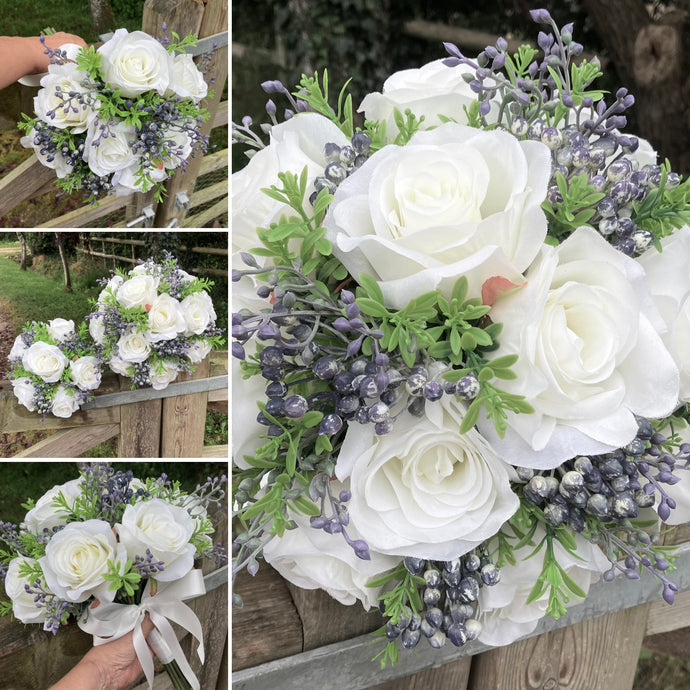 wedding bouquet of ivory roses and blue berries