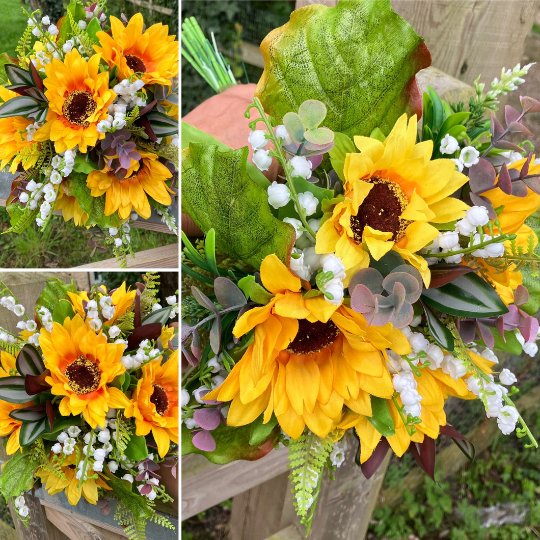 A wedding bouquet of artificial sunflowers and lily of the valley