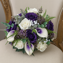 A wedding bouquet of ivory and purple faux silk rose and calla flowers