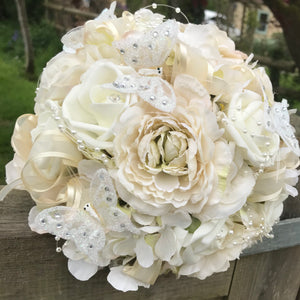 - artificial wedding bouquet featuring champagne and ivory flowers