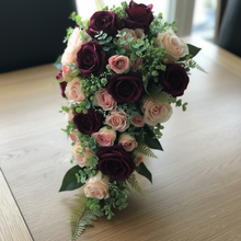 A bridal bouquet of burgundy & blush pink flowers