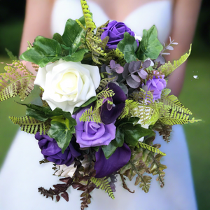 artificial wedding bouquet of purple and ivory flowers