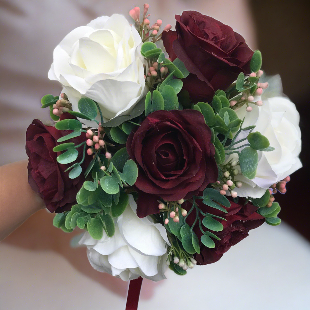 A wedding bouquet of ivory & burgundy silk rose flowers