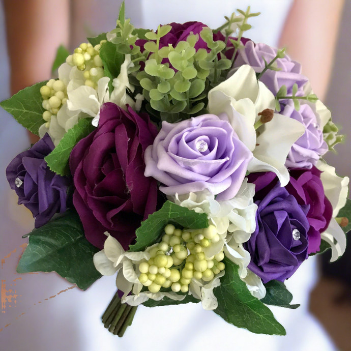 a wedding bouquet of ivory lilac and purple artificial roses hydrangea & lilies