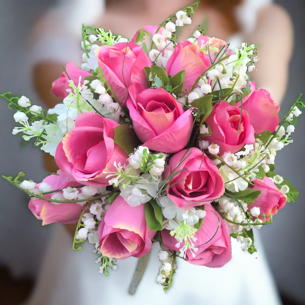 a brides wedding bouquet of artificial roses & lily of the valley