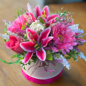 A flower arrangement in cream hat box