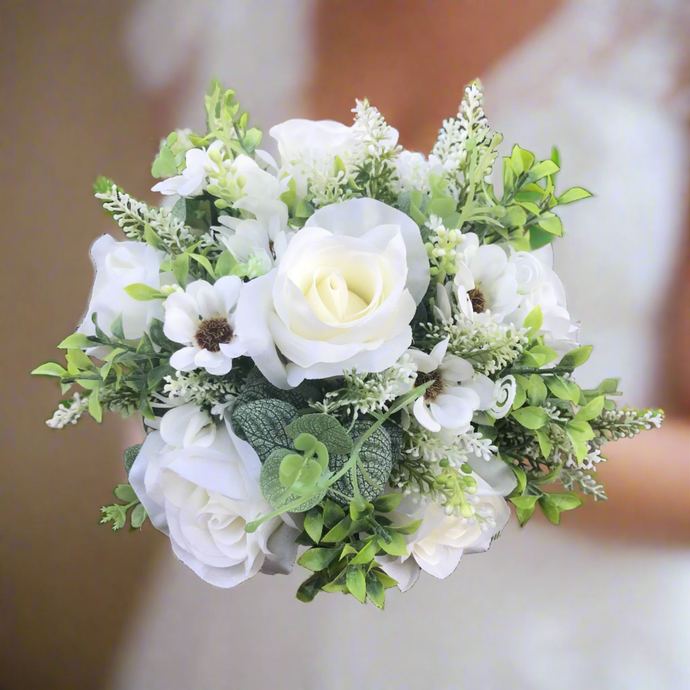 A brides wedding bouquet of artificial silk ivory roses and daisies