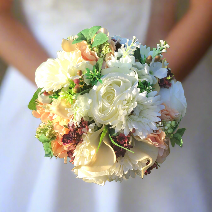 wedding bouquet of artificial ivory and peach flowers
