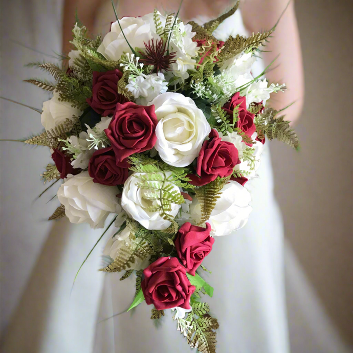 A teardrop bouquet collection of artificial ivory and burgundy roses