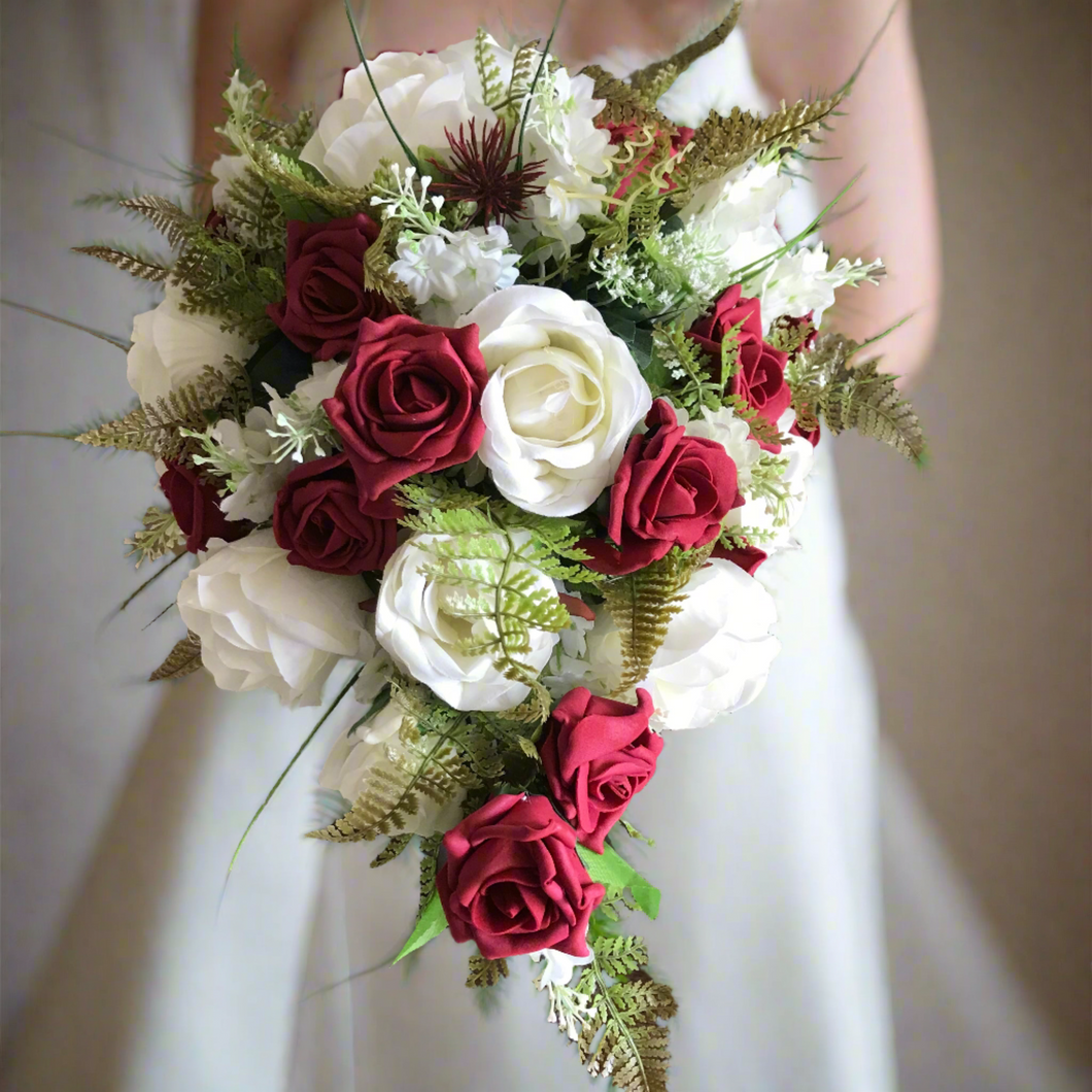 A teardrop bouquet collection of artificial ivory and red roses