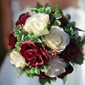 A wedding bouquet of ivory & burgundy silk rose flowers