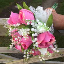 a brides wedding bouquet of artificial roses & lily of the valley