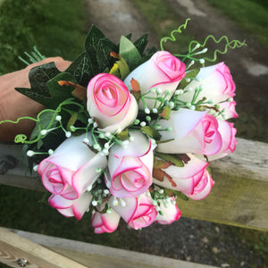 A bridal bouquet of artificial pink edged roses