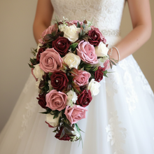 A teardrop bouquet of artificial burgundy, ivory & pink roses, crystals & pearls