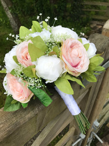 a wedding bouquet collection of artificial blush roses and peonies