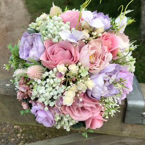 a wedding bouquet of artificial silk ivory hydrangea and lilac rose flowers