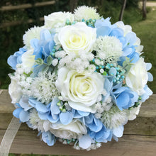 A brides bouquet of white/ivory and pale blue artificial silk flowers