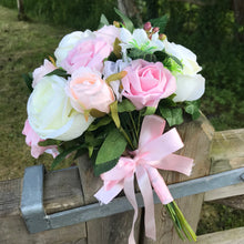 a wedding bouquet of artificial ivory peach & pink rose flowers