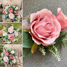 A teardrop bouquet of artificial pink and white roses