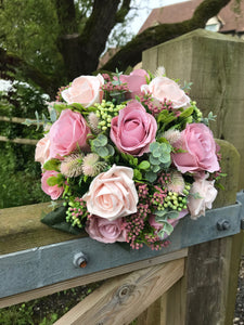 A bridal bouquet collection of dusky pink artificial silk roses and foliage