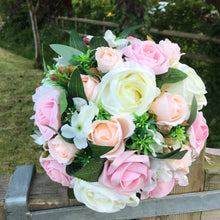 a wedding bouquet of artificial ivory peach & pink rose flowers